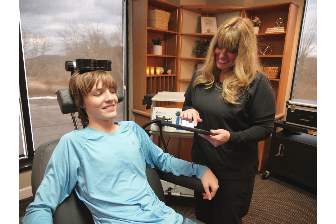 Frankie Plut receiving a PrTMS treatment from his mother Mary Plut. (James Dinonno Studios)