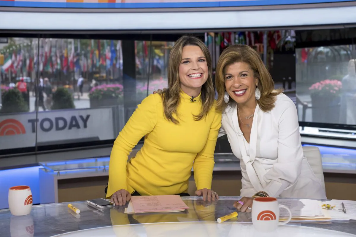 Co-anchors Savannah Guthrie (L) and Hoda Kotb pose on "Today" show set at NBC Studios in New York on June 27, 2018. (Charles Sykes/Invision/AP)