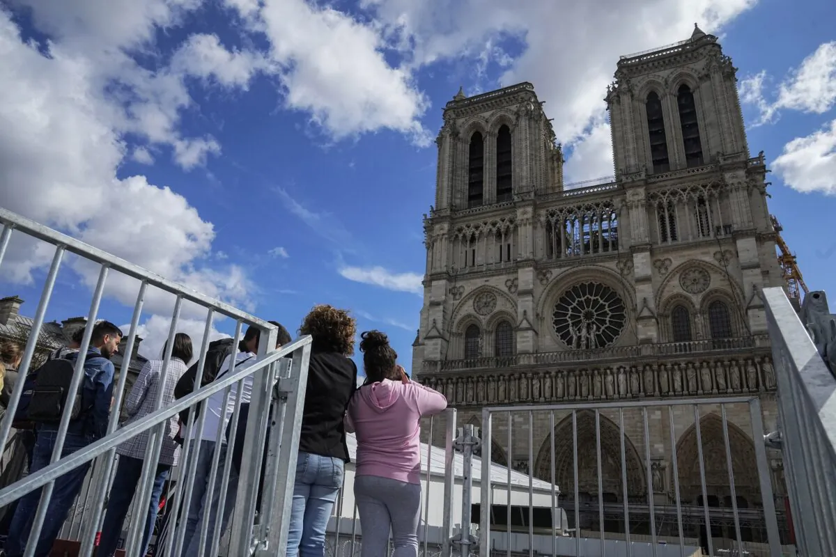 People have a close look of Notre Dame cathedral as they visit the rebuilding site during Heritage Day in Paris on Sept. 17, 2022. (Michel Euler/AP Photo)