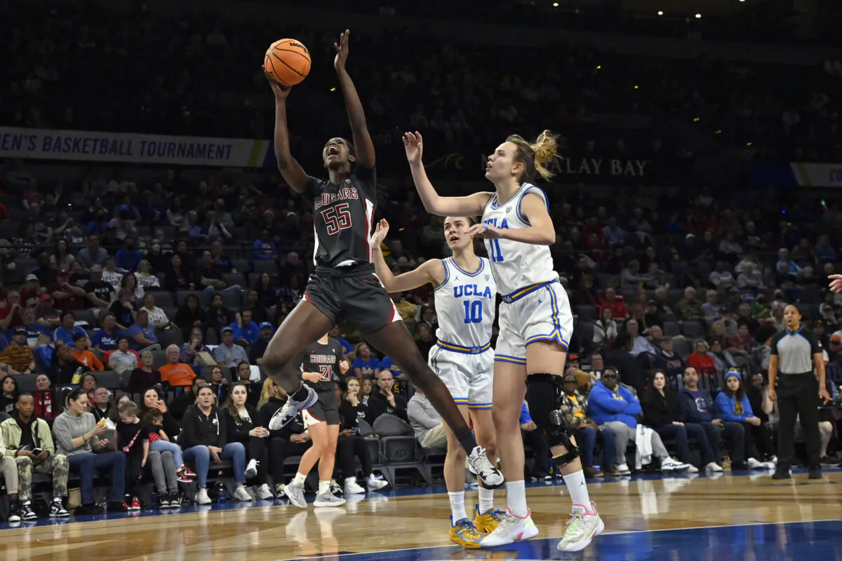 Washington State center Bella Murekatete (55) shoots against UCLA guard Gina Conti (10) and forward Emily Bessoir (11) during the first half of an NCAA college basketball game in the finals of the Pac-12 women's tournament in Las Vegas on March 5, 2023. (David Becker/AP Photo)