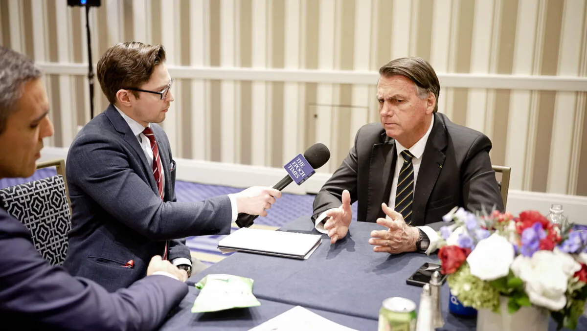 Brazil’s former president, Jair Bolsonaro (R), speaks to Epoch Times reporter Roman Balmakov at the Conservative Political Action Conference in Washington on March 4, 2023. (Oliver Trey/NTD)