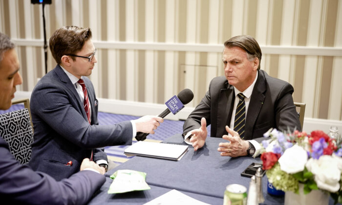 Brazil’s former President Jair Bolsonaro (R) speaks to Epoch Times reporter Roman Balmakov at the Conservative Political Action Conference in Washington, D.C., on March 4, 2023. (Oliver Trey/NTD)