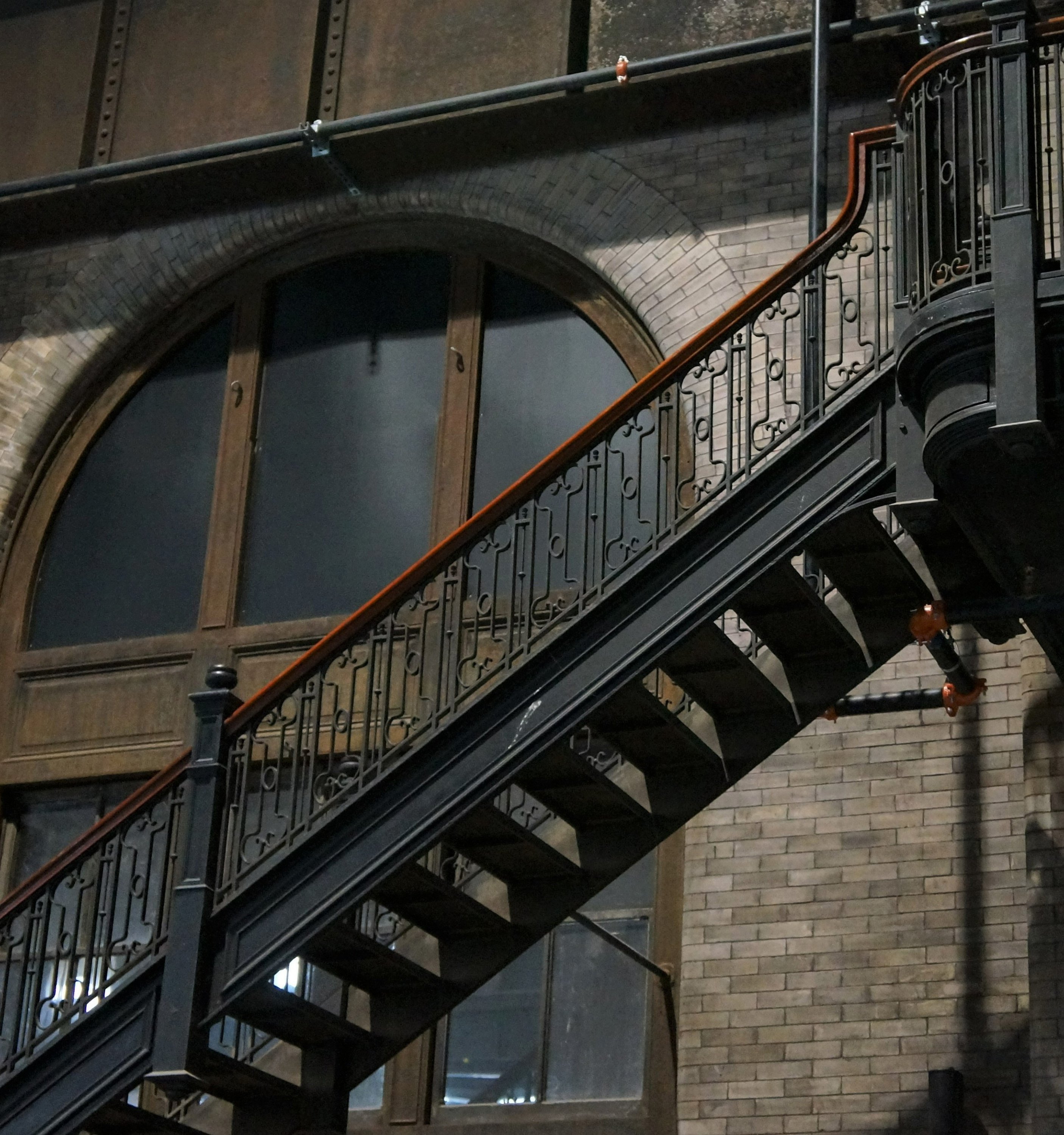 Wrought-iron staircases and arched windows in the plant