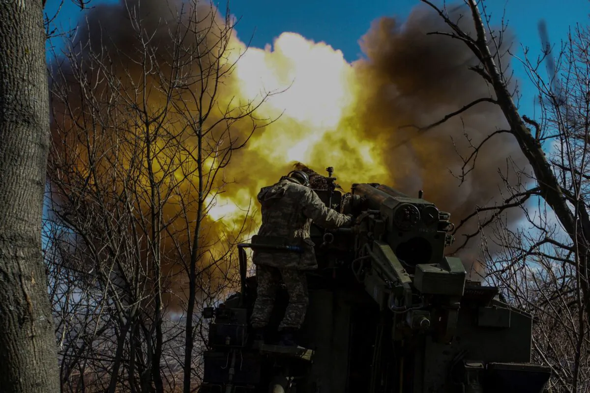 Ukrainian servicemen fire a 2S5 Giatsint-S self-propelled howitzer towards Russian troops outside the frontline town of Bakhmut, in Donetsk region, Ukraine, on March 5, 2023. (Anna Kudriavtseva/Reuters)