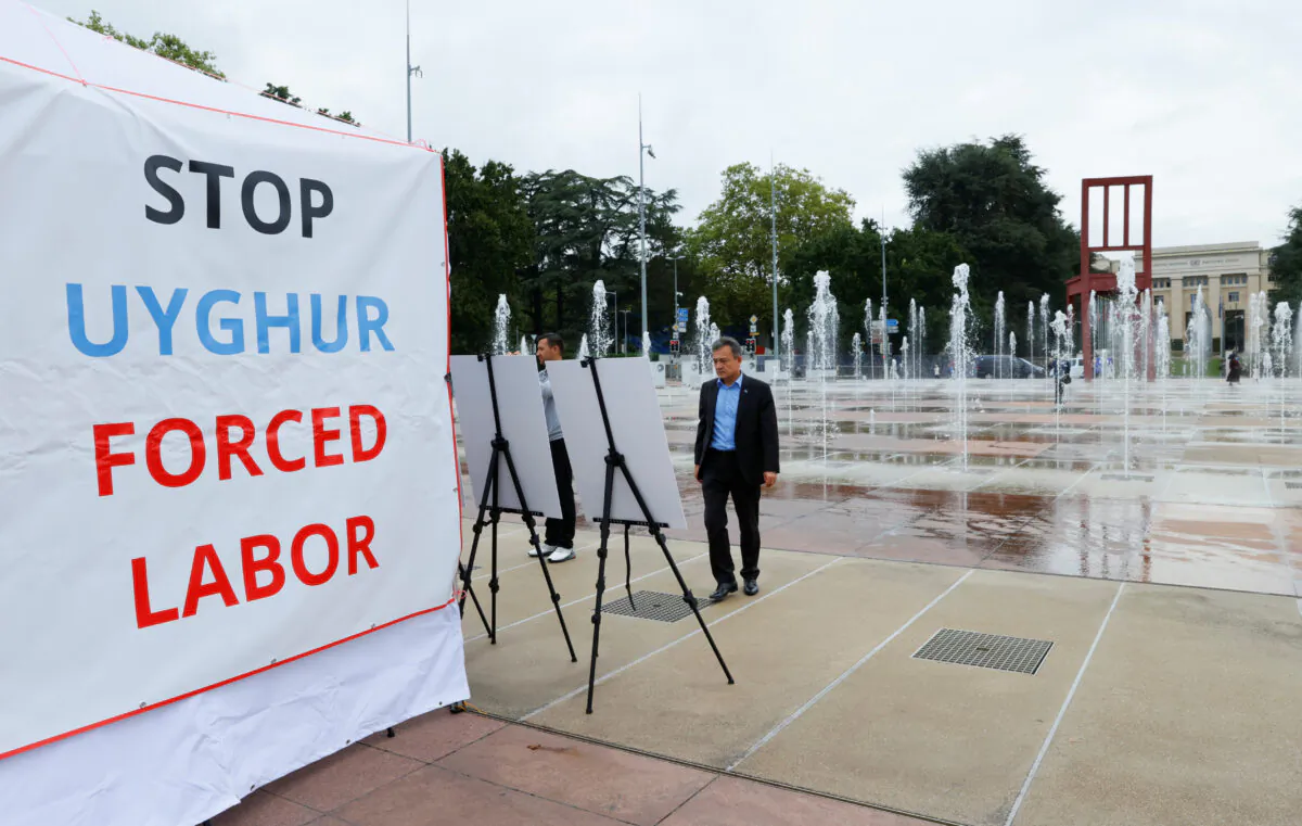Dolkun Isa, President of the World Uyghur Congress, poses at a U.S.-backed Uyghur photo exhibit of dozens of people who are missing or alleged to be held in CCP-run camps in Xinjiang, China in front of the United Nations in Geneva, Switzerland, on  Sept. 16, 2021. (Denis Balibouse /Reuters)