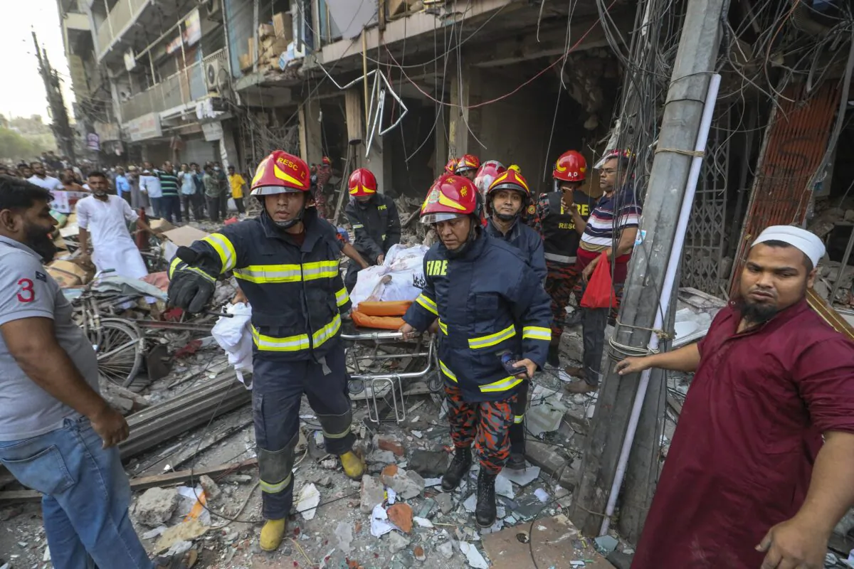 Fire officials carry a body of a victim after an explosion in Dhaka, Bangladesh, on March 7, 2023. (Abdul Goni/AP Photo)