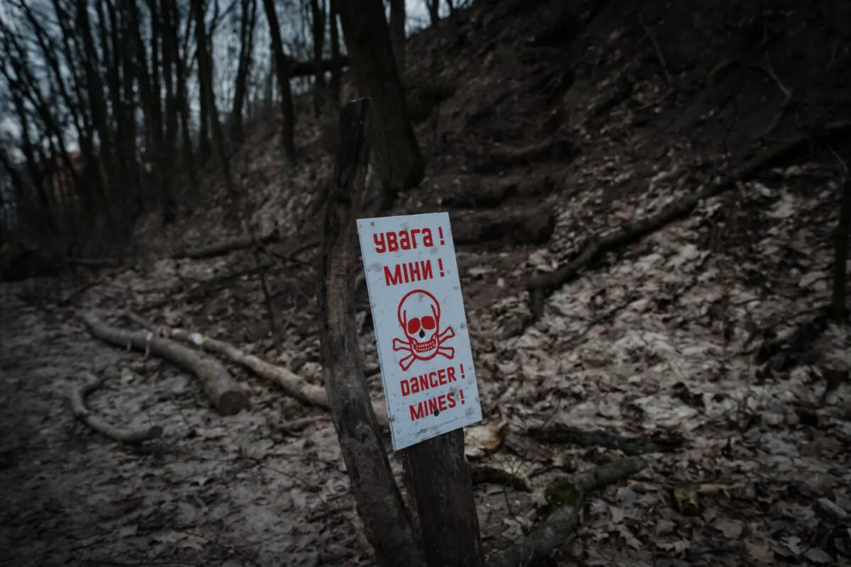 A billboard indicates the presence of landmines at the position of a Ukrainian volunteer unit in a suburb of Kyiv on Feb. 28, 2023. (Yasuyoshi Chiba/AFP via Getty Images)