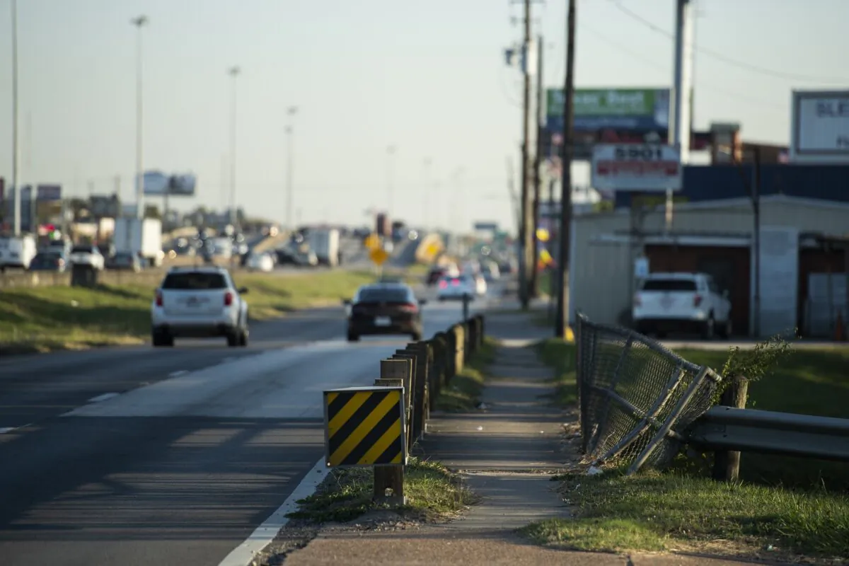 Traffic flows south along Interstate 45 and the frontage road next to a sidewalk in Houston on Nov. 19, 2021. (Justin Rex/AP Photo)