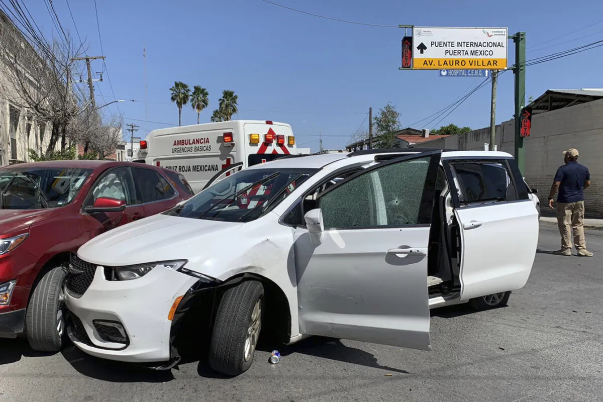A member of the Mexican security forces stands next to a white minivan with North Carolina plates and several bullet holes, at the crime scene where gunmen kidnapped four U.S. citizens who crossed into Mexico from Texas, on March 3, 2023. (AP Photo)