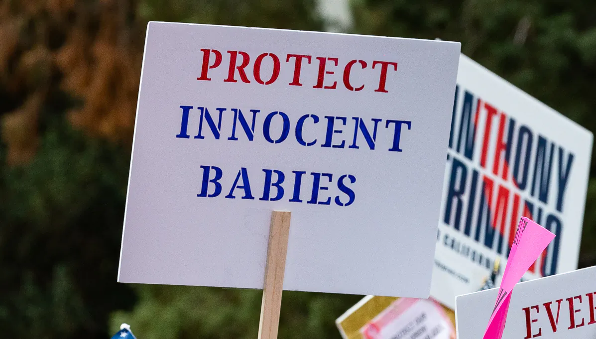 Pro-life demonstrators hold signs outside the California Capitol in Sacramento on April 19, 2022. (John Fredricks/The Epoch Times)