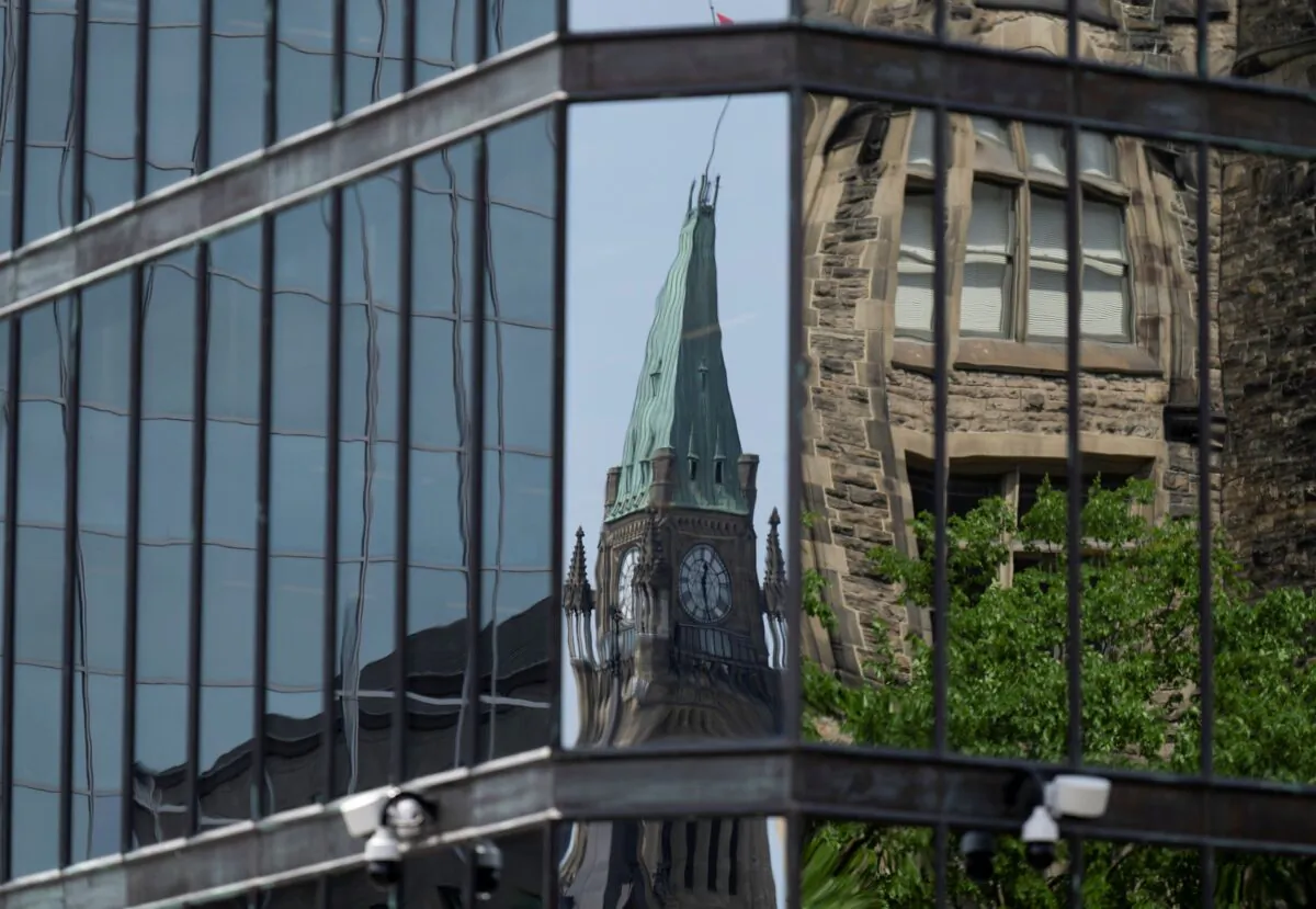 The Peace tower on Parliament Hill is reflected in the windows of the Bank of Canada in Ottawa on June 1, 2022. (The Canadian Press/Adrian Wyld)