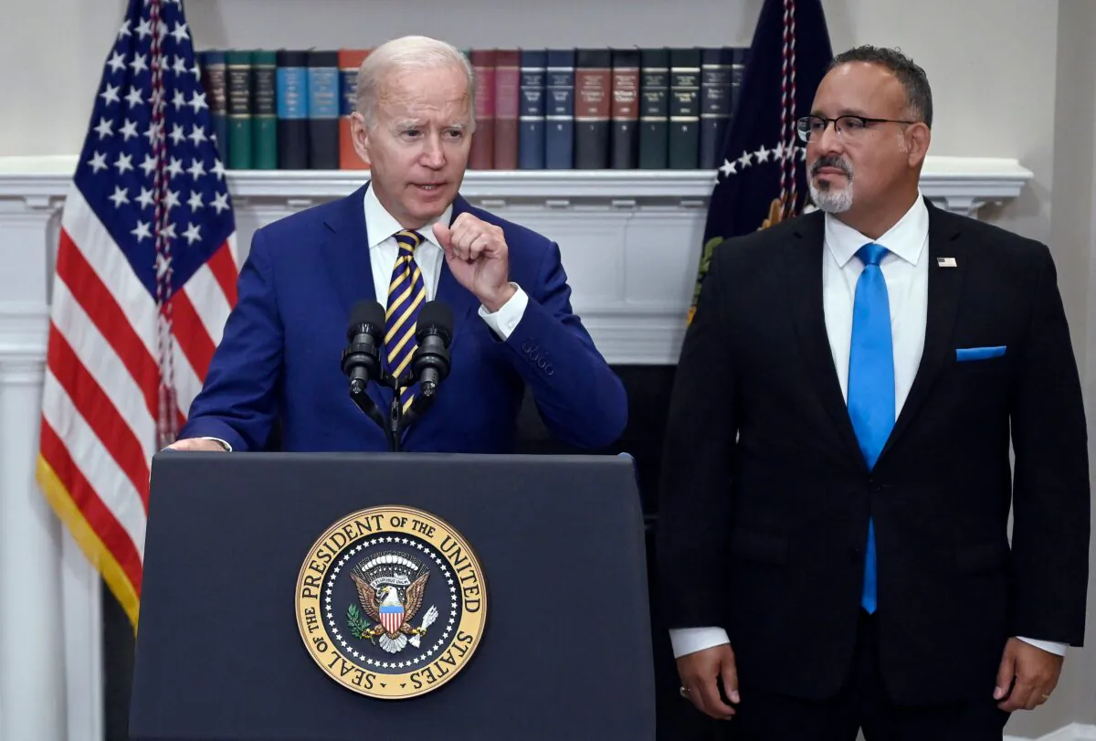 President Joe Biden announces student loan relief with Education Secretary Miguel Cardona (R) in the Roosevelt Room of the White House in Washington on Aug. 24, 2022. (Olivier Douliery/AFP via Getty Images)
