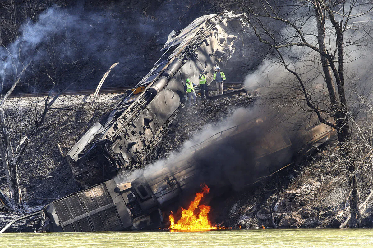 Smoke fills the sky after an empty CSX coal train hit a rockslide along tracks causing a fiery derailment in a remote area just south of Sandstone, W.Va., on March 8, 2023. (Jenny Harnish/The Register-Herald via AP)