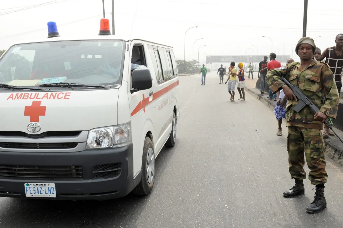 An ambulance drives past a soldier standing away from protesters at Ojota district in Lagos, Nigeria, on Jan. 16, 2012. (Pius Utomi Ekpei/AFP via Getty Images)