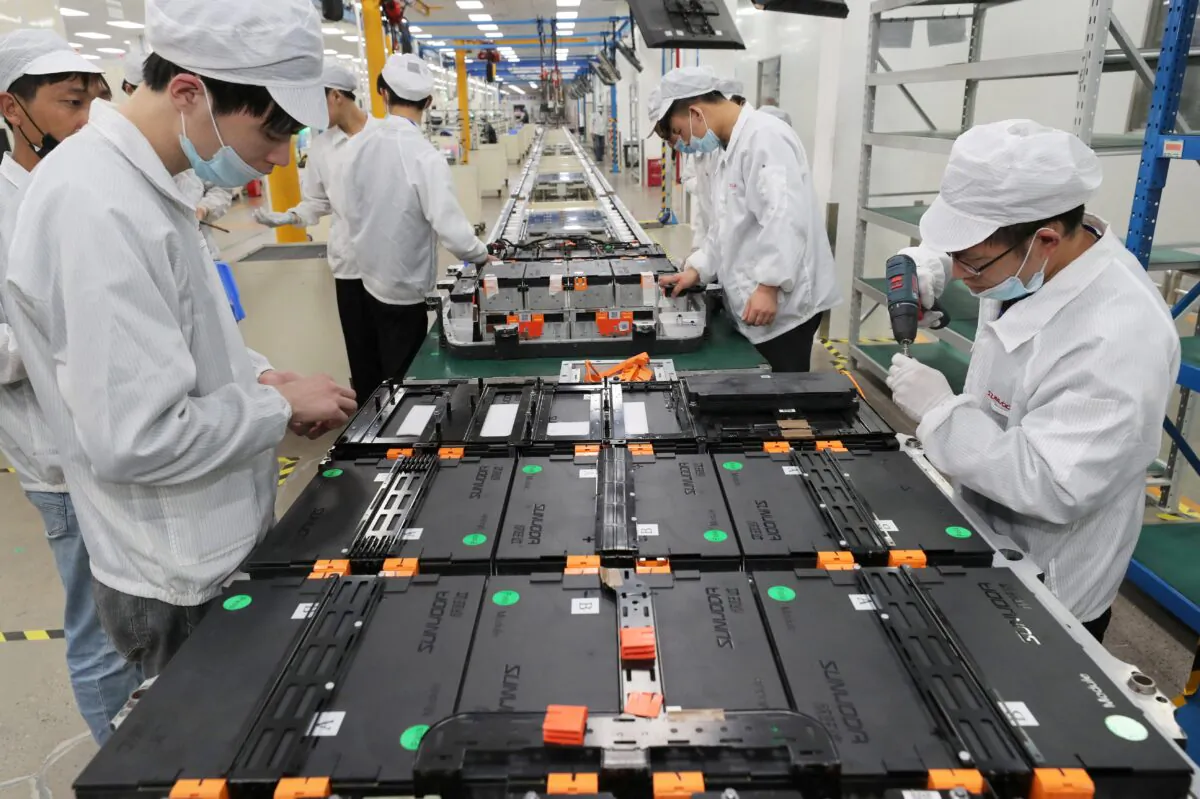 Workers at a factory for Xinwangda Electric Vehicle Battery Co., which makes lithium batteries for electric cars and other uses, in Nanjing in China's eastern Jiangsu Province, on March 12, 2021. (STR/AFP via Getty Images)