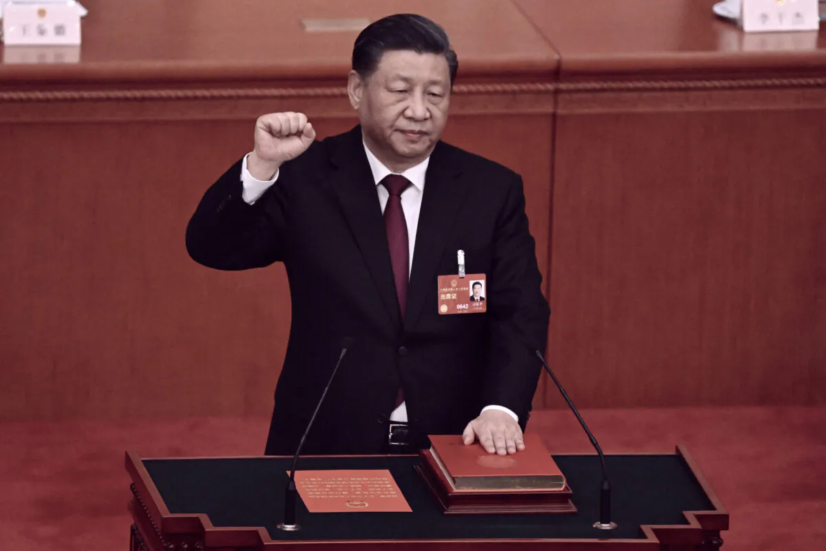 China's leader Xi Jinping swears under oath after being firmly confirmed as head of the state for a third term during the third plenary session of the National People's Congress (NPC) in Beijing on March 10, 2023. (Noel Celis/AFP via Getty Images)