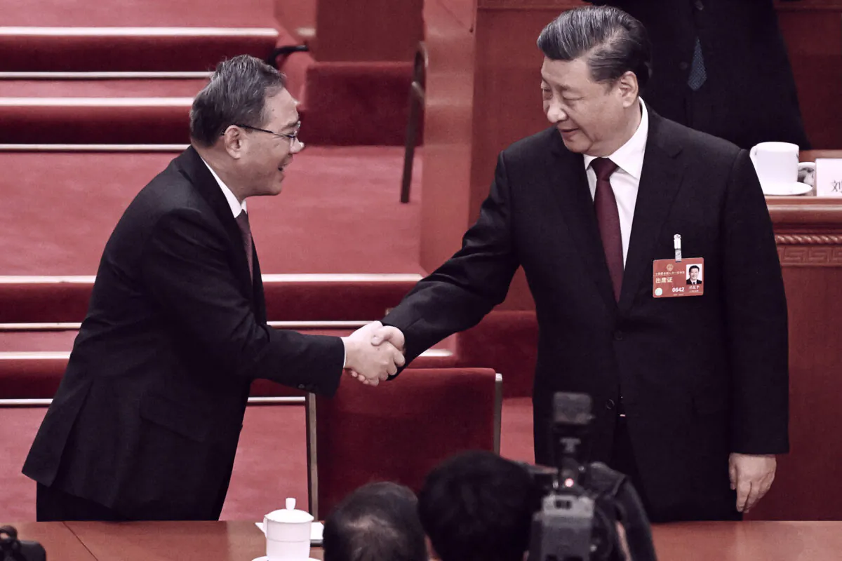 Chinese leader Xi Jinping (R) is congratulated by Politburo Standing Committee member Li Qiang after being confirmed as head of the Communist Party for a third term during the third plenary session of the National People's Congress in Beijing, China on March 10, 2023. (Noel Celis/AFP via Getty Images)