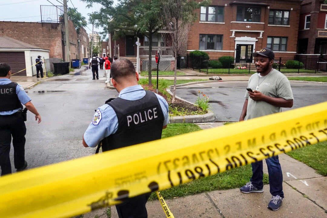 Police secure the scene of a shooting in the Auburn Gresham neighborhood in Chicago, Ill., on July 21, 2020. (Scott Olson/Getty Images)
