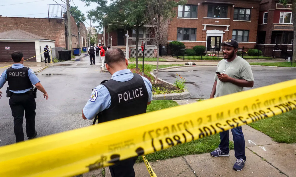 Police secure the scene of a shooting in the Auburn Gresham neighborhood in Chicago, Ill., on July 21, 2020. (Scott Olson/Getty Images)