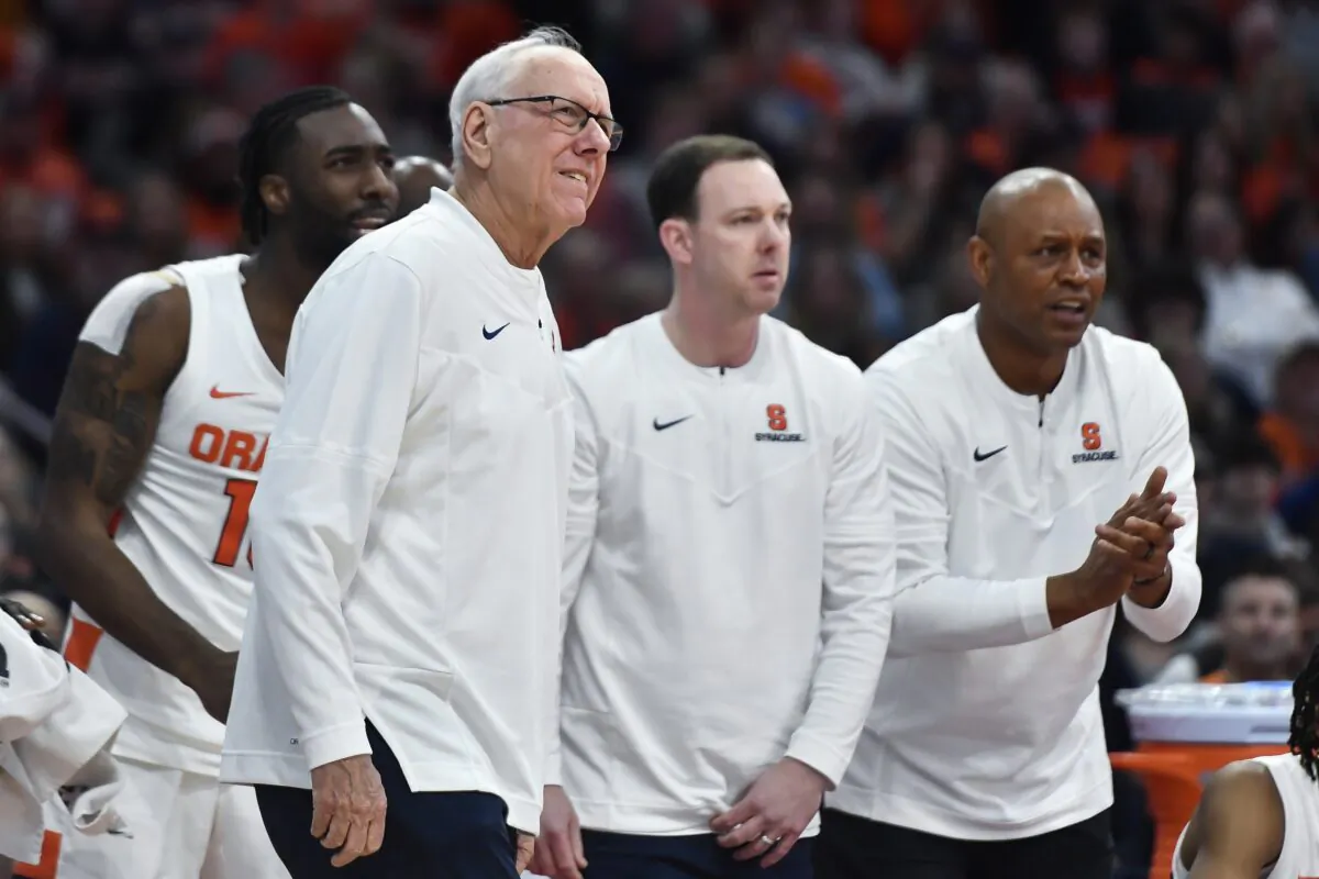 Syracuse head coach Jim Boeheim (L) assistant coach Gerry McNamara (C) and associate head coach Adrian Autry watch from the sideline during the second half of an NCAA college basketball game against Boston College in Syracuse, N.Y., on Dec. 31, 2022. (Adrian Kraus/AP Photo)