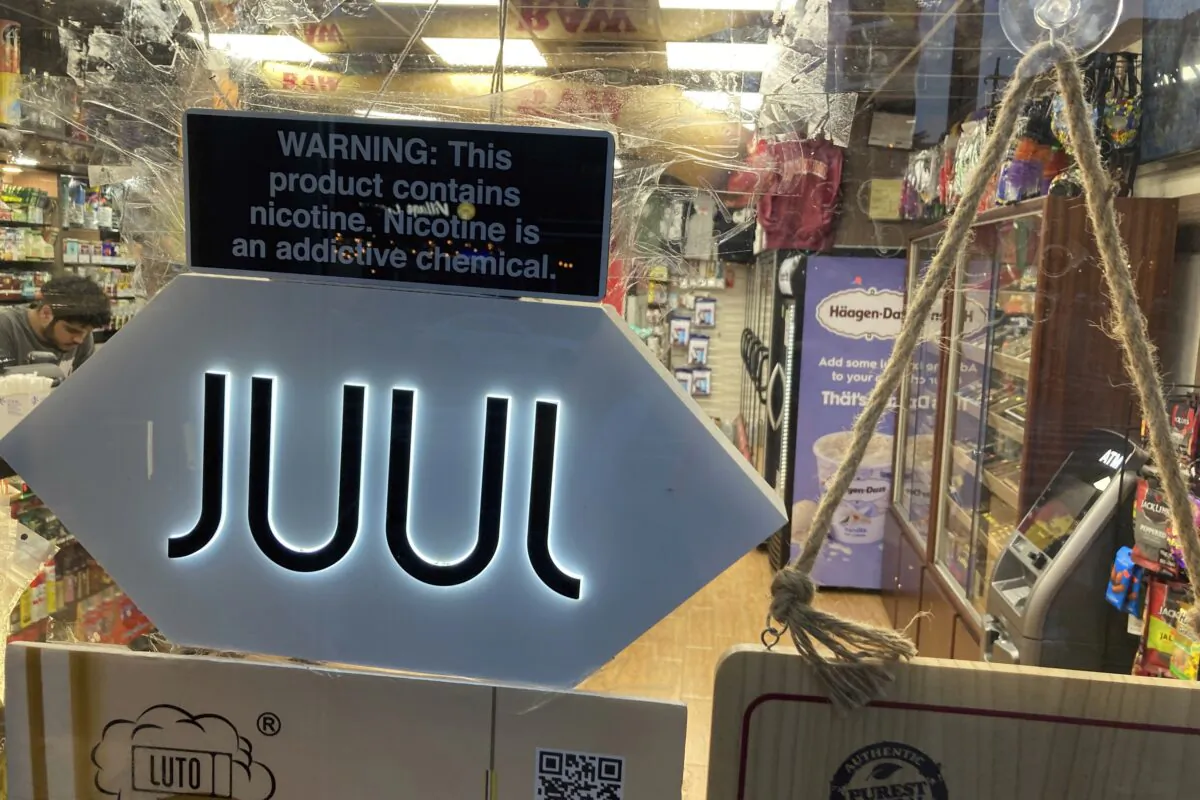 A Juul sign hangs in the front window of a bodega convenience store in New York on June 25, 2022. (Ted Shaffrey/AP Photo)