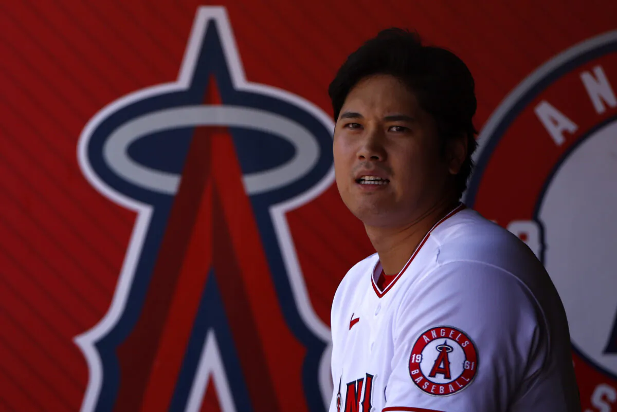 Shohei Ohtani sits in dugout at at Angel Stadium of Anaheim in Anaheim, Calif., on Oct. 2, 2022 . (Ronald Martinez/Getty Images)