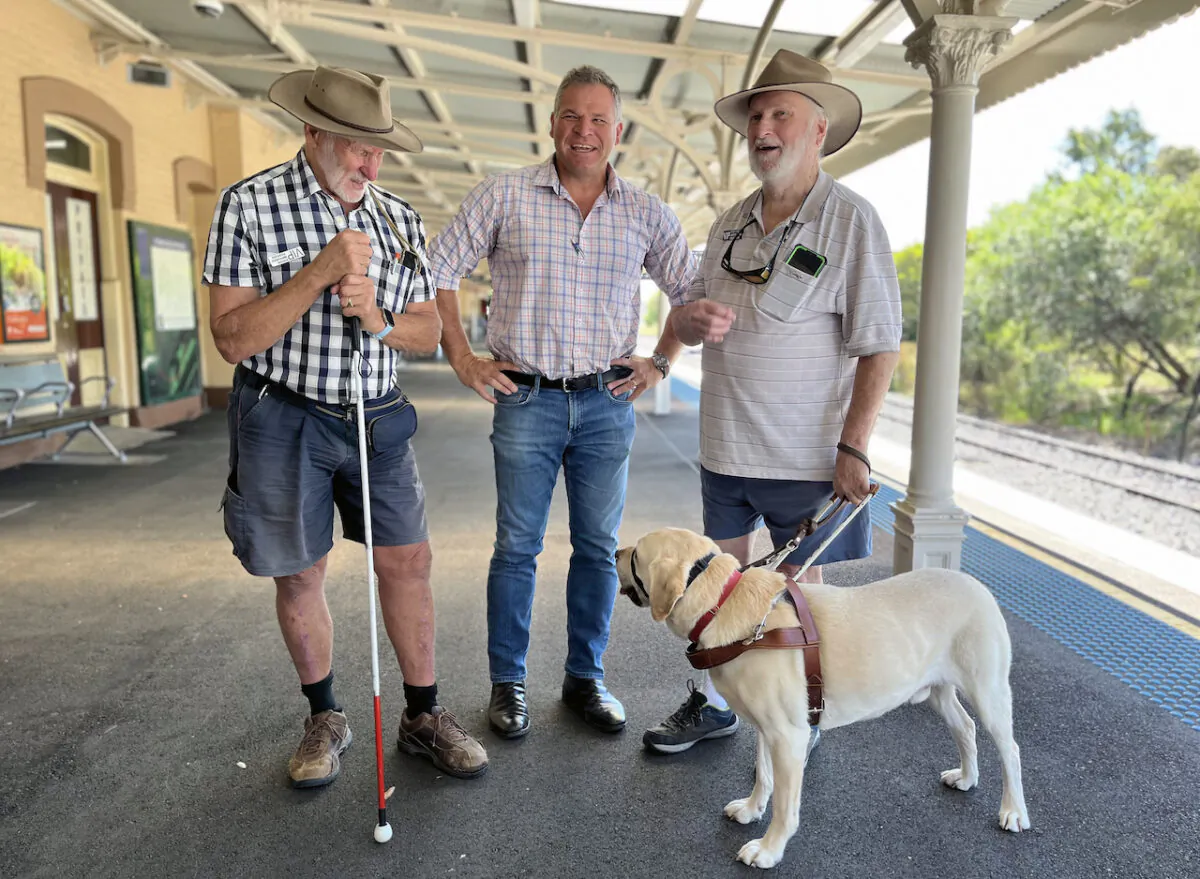 (L-R) Colin Spicer, Orange independent MP Philip Donato, and Doug Spicer, with guide dog Rusty at Orange train station in the Central West region of New South Wales, March 6, 2023. Mr Donato was one of three rural MPs to quit the Shooters, Fishers and Farmers party in 2022 to run as an independent. (AAP Image/Stephanie Gardiner)
