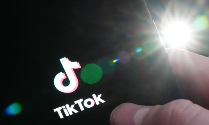 The TikTok startup page is displayed on an iPhone in Ottawa on Feb. 27, 2023. (The Canadian Press/Sean Kilpatrick)
