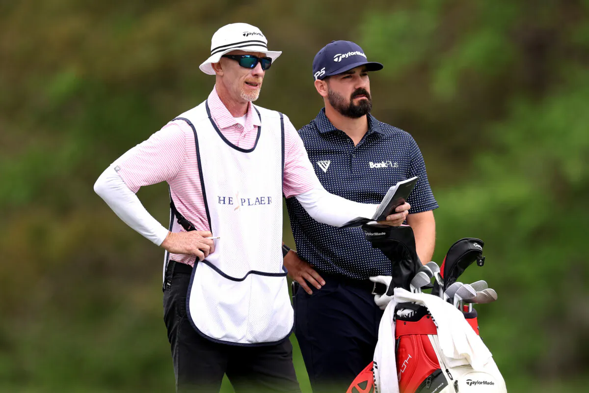 Chad Ramey of the United States waits with his caddie Ryan Goble on the 14th hole during the first round of THE PLAYERS Championship on THE PLAYERS Stadium Course at TPC Sawgrass in Ponte Vedra Beach, Fla., on March 9, 2023. (Richard Heathcote/Getty Images)