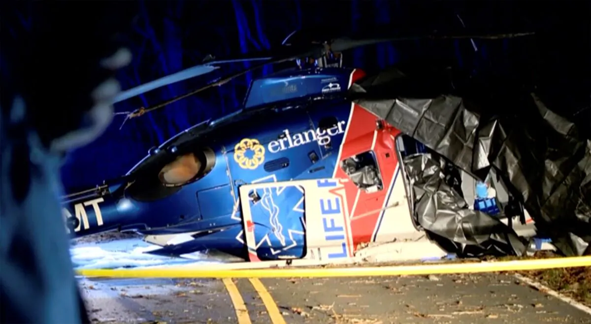 This image from a video shows a wrecked helicopter in Macon Country, N.C., on March 10, 2023. (WLOS-TV via AP)