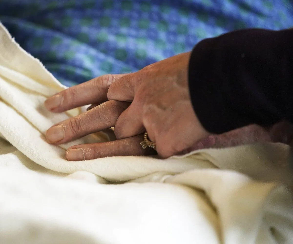 A patient has his hand held at a hospital, in a file photo. (The Canadian Press/David Joles-Star Tribune via AP)