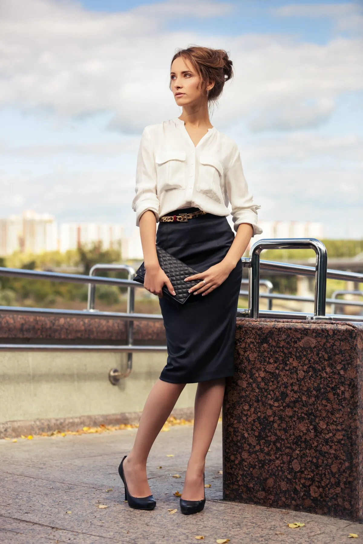 To wear a 1940's inspired contemporary look, pair a blouse with a looser pencil, A-line, or pleated skirt, and aim for no shorter than knee-length and no longer than mid-calf. (wrangler/Shutterstock)