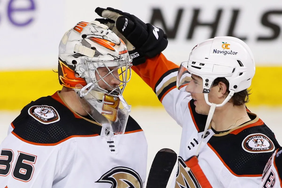 Anaheim Ducks goalie John Gibson (L), is congratulated by Colton White after defeating the Calgary Flames in NHL hockey game action in Calgary, Alberta, on March 10, 2023. (Larry MacDougal/The Canadian Press via AP)