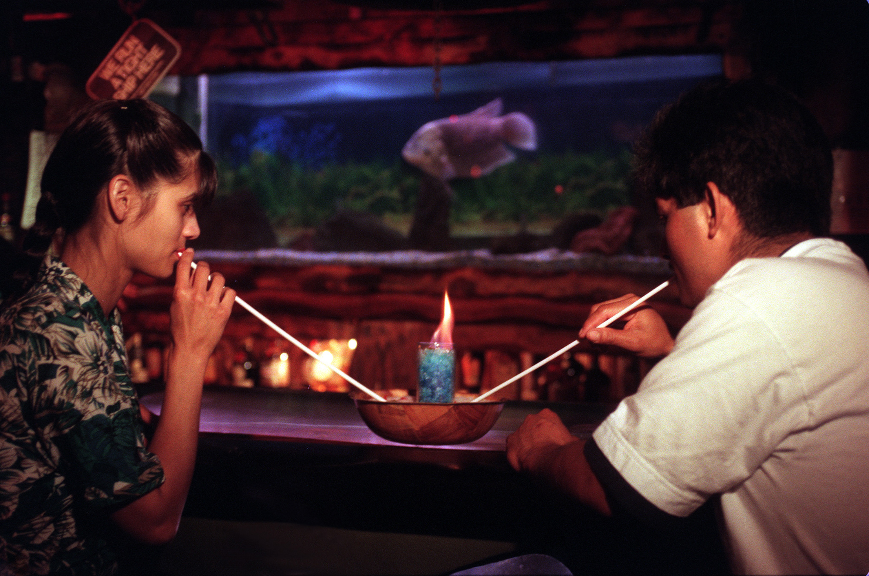 A young couple share a flaming honey bowl in 1997 at the now-closed Bahooka Ribs & Grog in Rosemead, California. 