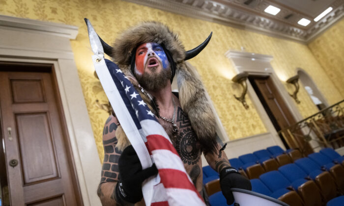 Jacob Chansley, also known as the ‘QAnon Shaman,’ inside the U.S. Senate chamber after the U.S. Capitol was breached on Jan. 6, 2021. (Win McNamee/Getty Images)