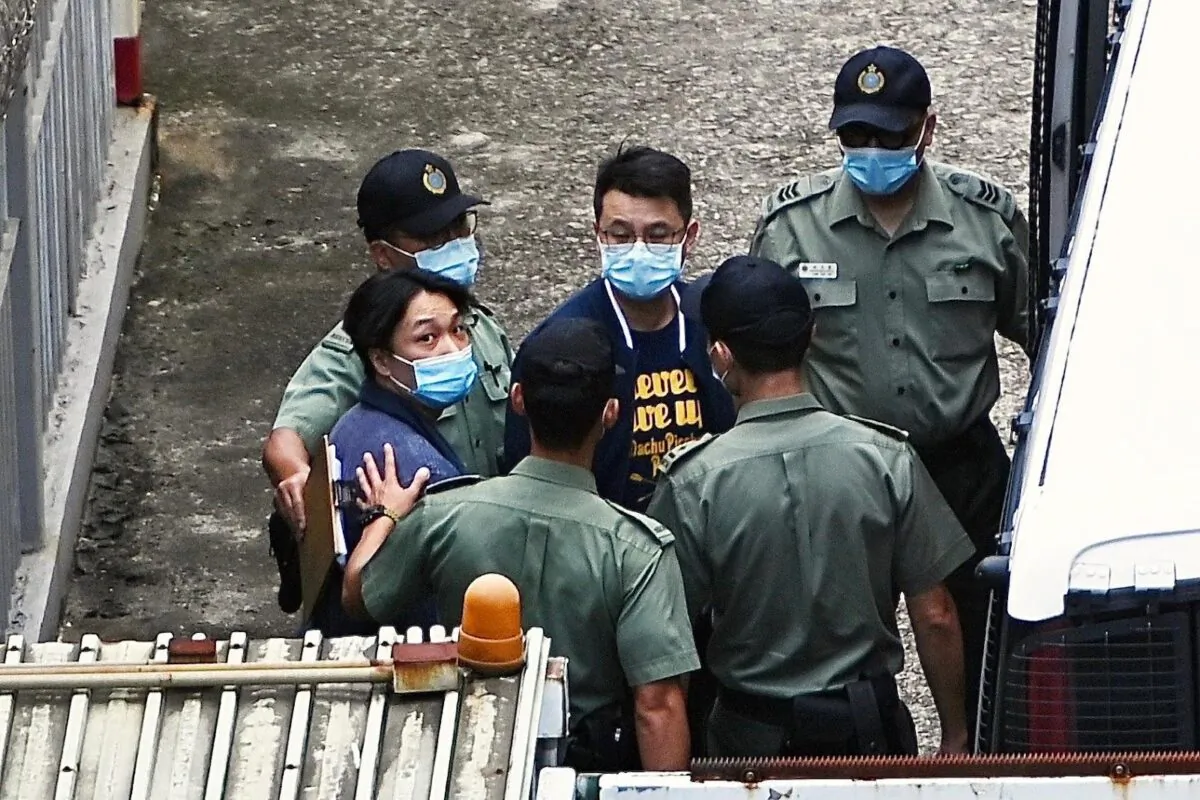 The police escorted two democrats (in plain clothes) Jimmy Sham Tsz-kit (L) and Andrew Wan Siu-kin (R) into a prison van and went to the court to stand trial, in Hong Kong, on July 8, 2021. (Sung Pi-Lung/The Epoch Times)