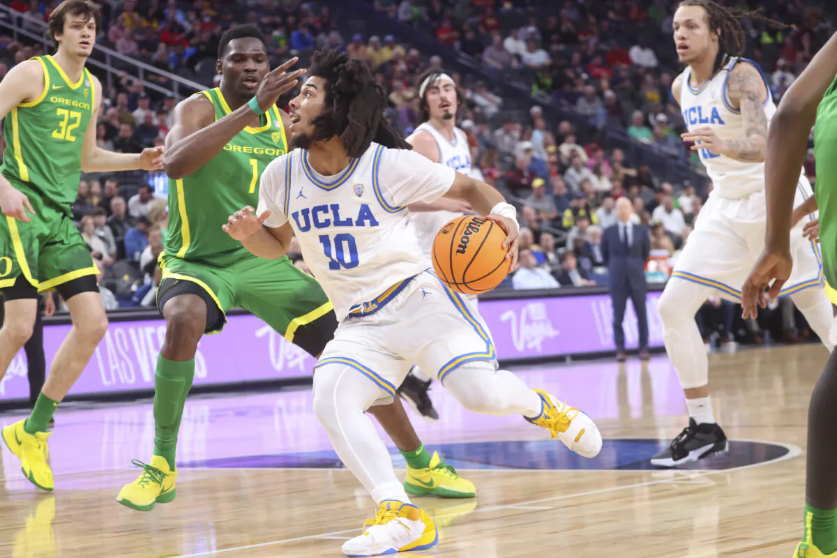 UCLA guard Tyger Campbell (10) drives to the basket against Oregon center N'Faly Dante (1) during the first half of an NCAA college basketball game in the quarterfinals of the Pac-12 Tournament in Las Vegas on  March 10, 2023. (Chase Stevens/AP Photo)