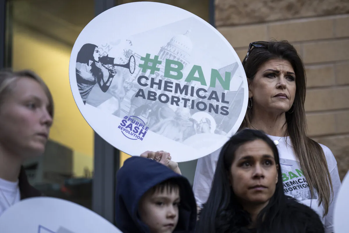 Protesters demonstrate against the availability of abortion pills at neighborhood pharmacies outside of a CVS Pharmacy, in Washington, on Jan. 18, 2023. (Drew Angerer/Getty Images)