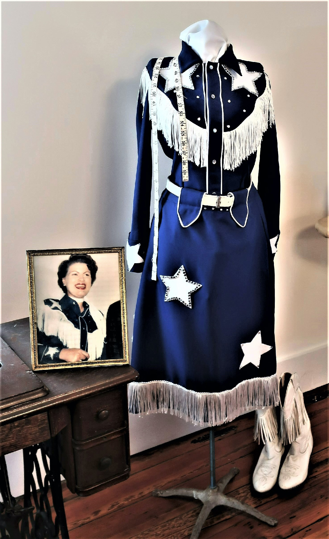 A portrait and outfit of Patsy Cline on display