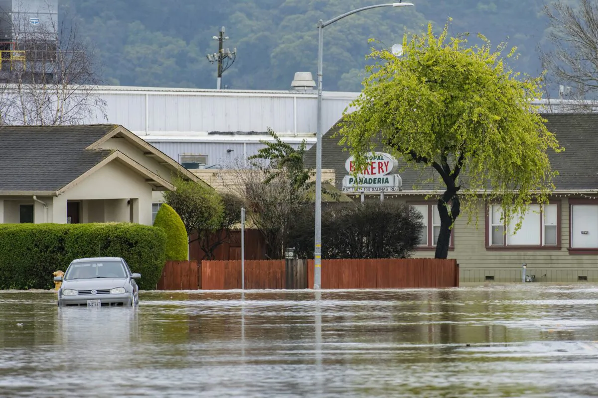 A vehicle is stuck in floodwaters in Watsonville, Calif., on March 11, 2023. (Nic Coury/AP Photo)
