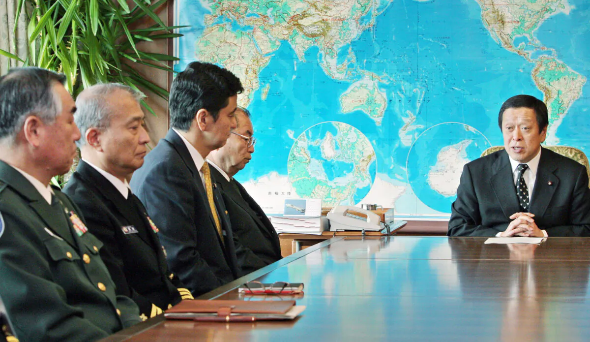 Japanese Defence Minister Yasukazu Hamada (R) speaks to Japanese Maritime Defence Force officers (L) at the Defence Ministry in Tokyo on January 28, 2009. (AFP/AFP via Getty Images)