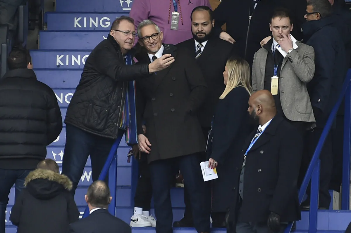 BBC's Match of the Day presenter Gary Lineker poses with a fan for selfies in the stands prior to the English Premier League soccer match between Leicester City and Chelsea at King Power stadium in Leicester, England, on March 11, 2023. (Rui Vieira/AP Photo)