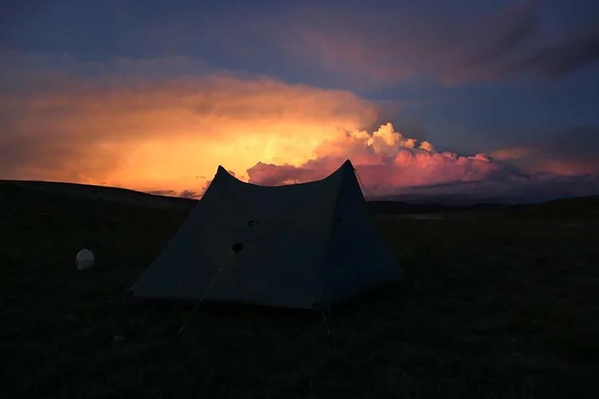Clouds build as the sun sets over India Wood's tent during her walk across Colorado.
