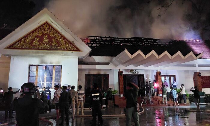 Local authorities try to put out a fire at Royal Residence in Siem Reap, Cambodia, on March 12, 2023. (AKP via AP)