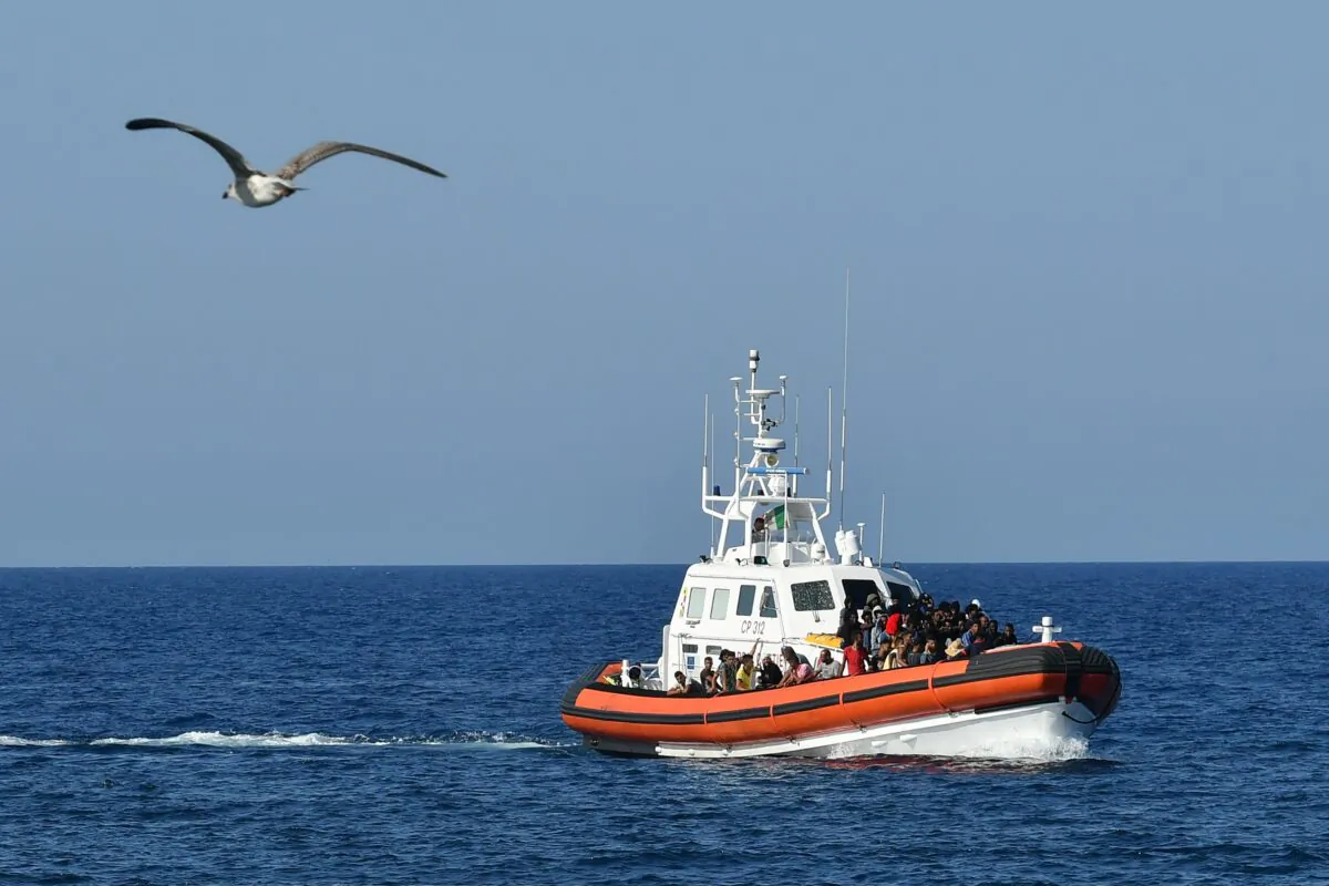 An Italian Guardia Costiera (Coast Guard) boat with migrants arrives in the port of the Italian Pelagie Island of Lampedusa on Aug. 1, 2020. (Alberto Pizzoli/AFP via Getty Images)