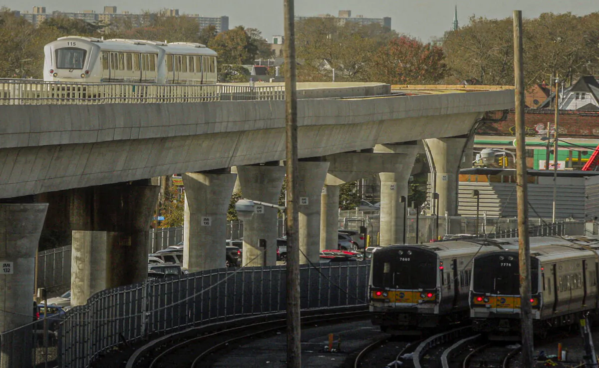The JFK airport Airtrain (L) travels on overhead tracks above Long Island Rail Road trains near Jamaica Station in Queens, New York, on Nov. 1, 2012. (Frank Franklin II/AP Photo)