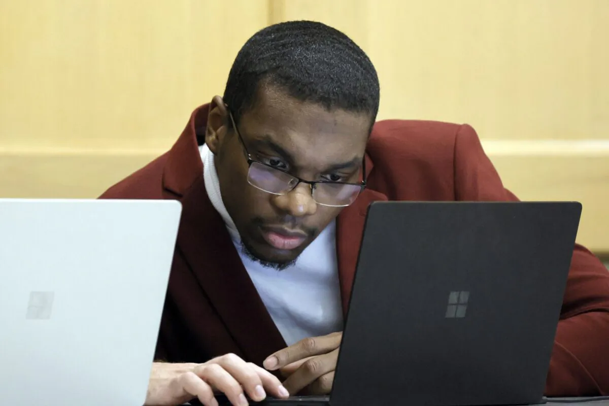 Shooting suspect Michael Boatwright looks at his attorney's computer at the defense table on the fourth day of jury deliberations in the XXXTentacion murder trial at the Broward County Courthouse in Fort Lauderdale, Fla., on March 13, 2023. (Amy Beth Bennett/South Florida Sun-Sentinel via AP, Pool)