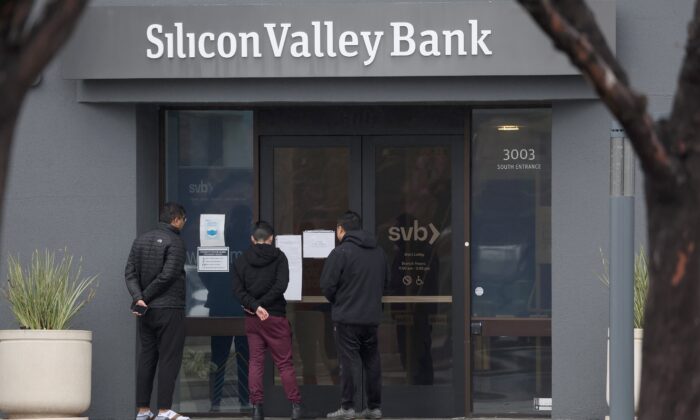 Employees stand outside of the shuttered Silicon Valley Bank (SVB) headquarters in Santa Clara, Calif., on March 10, 2023. (Justin Sullivan/Getty Images)