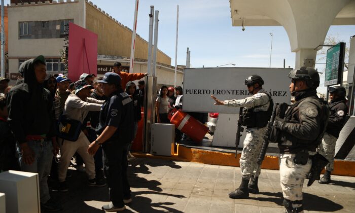 Illegal immigrants, mostly of Venezuelan origin, attempt to forcibly cross into the United States at the Paso del Norte International Bridge in Ciudad Juarez, Chihuahua, Mexico, on March 12, 2023. (HERIKA MARTINEZ/AFP via Getty Images)
