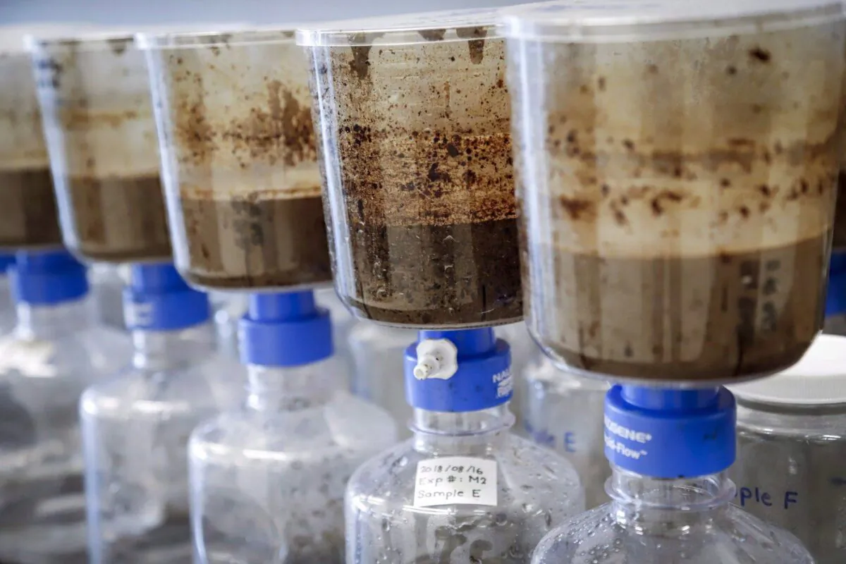 Tailings samples are being tested during a tour of Imperial's oil sands research centre in Calgary on Aug. 28, 2018. (The Canadian Press/Jeff McIntosh)